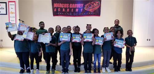 Students holding up Certificates
